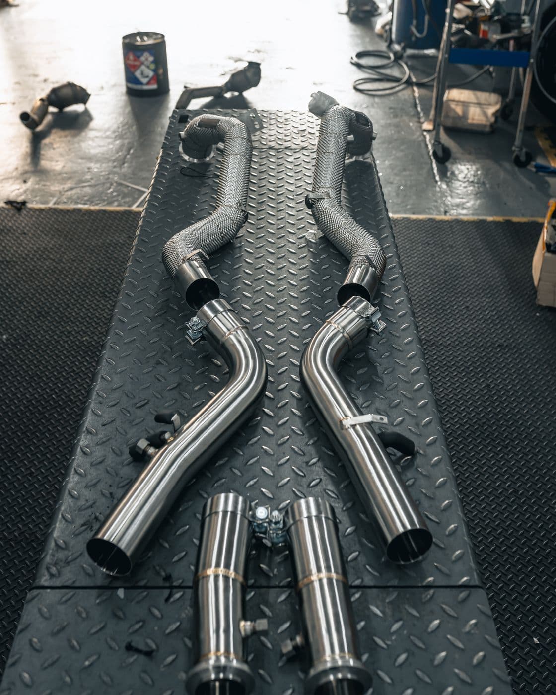 Stainless exhaust sections laid out before fitting