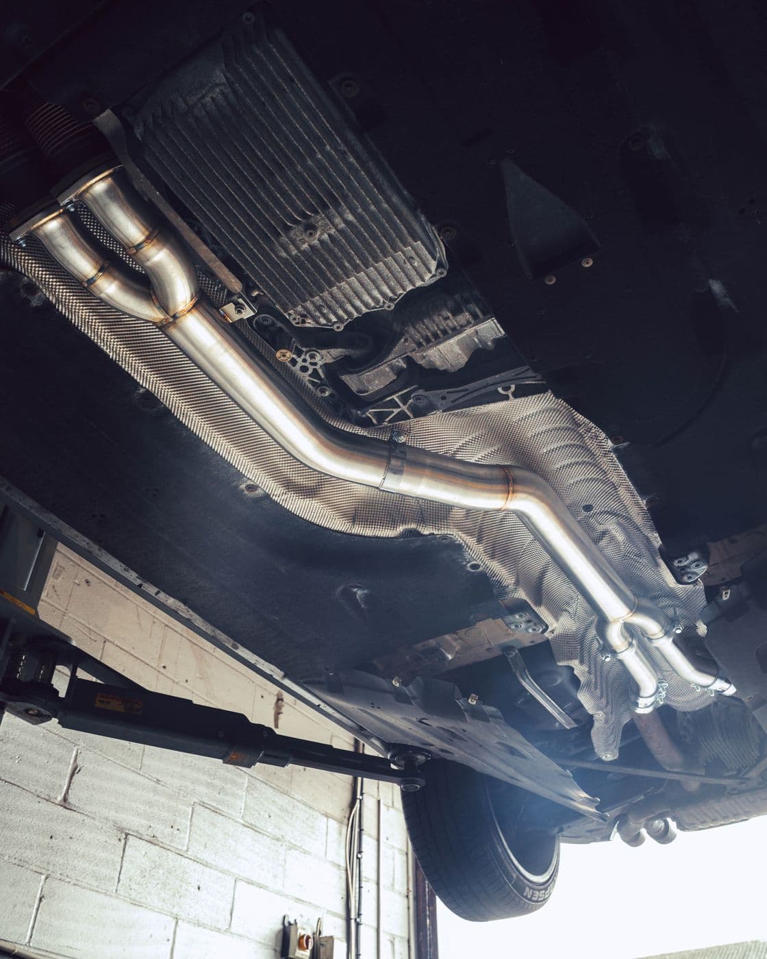 Exhaust system fitted under a BMW